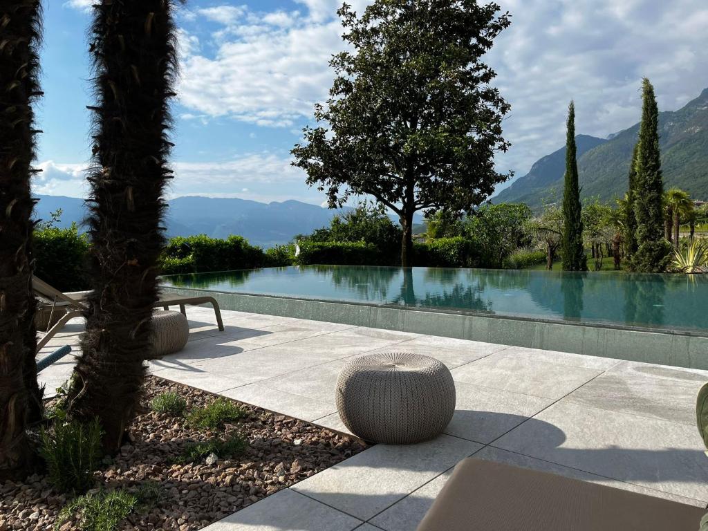 a swimming pool with a bench next to aitating at Das Wanda in Caldaro