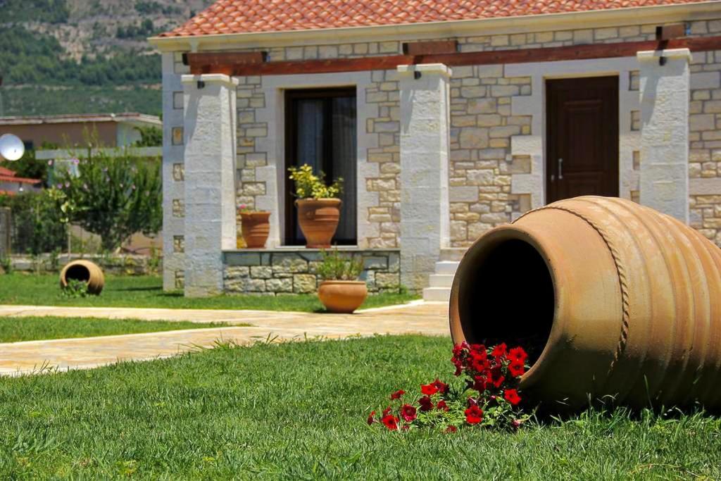 a house with a large barrel in the grass at Villa Maria 1 in Gliki
