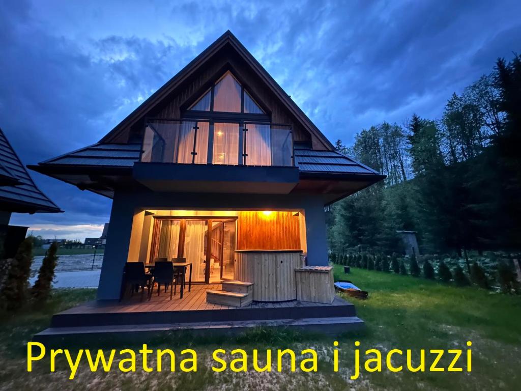 a house with a large window on the side of it at Prywatna Sauna i jacuzzi! Tatra Spa Witów in Witów