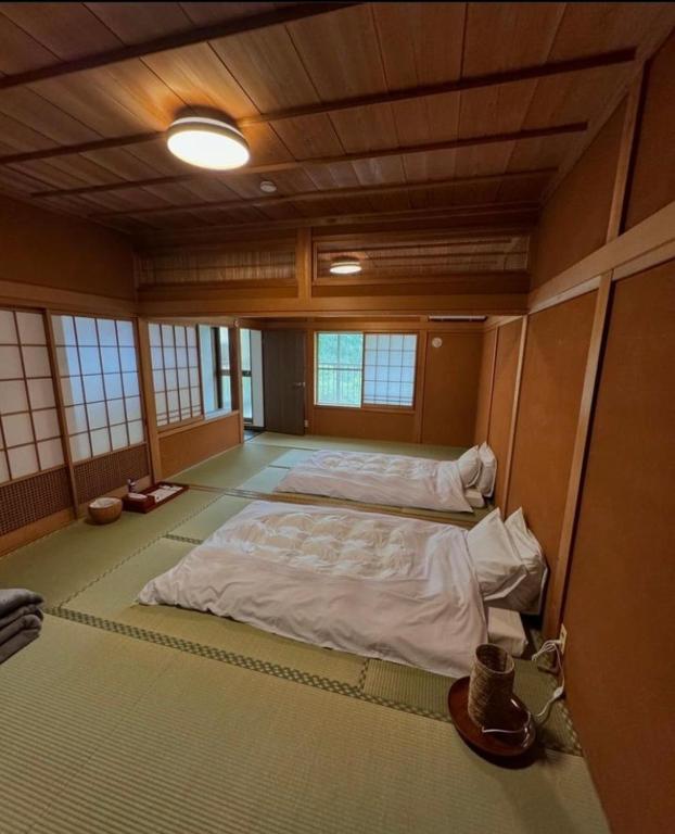 Postel nebo postele na pokoji v ubytování GUESTHOUSE YANAGIYA