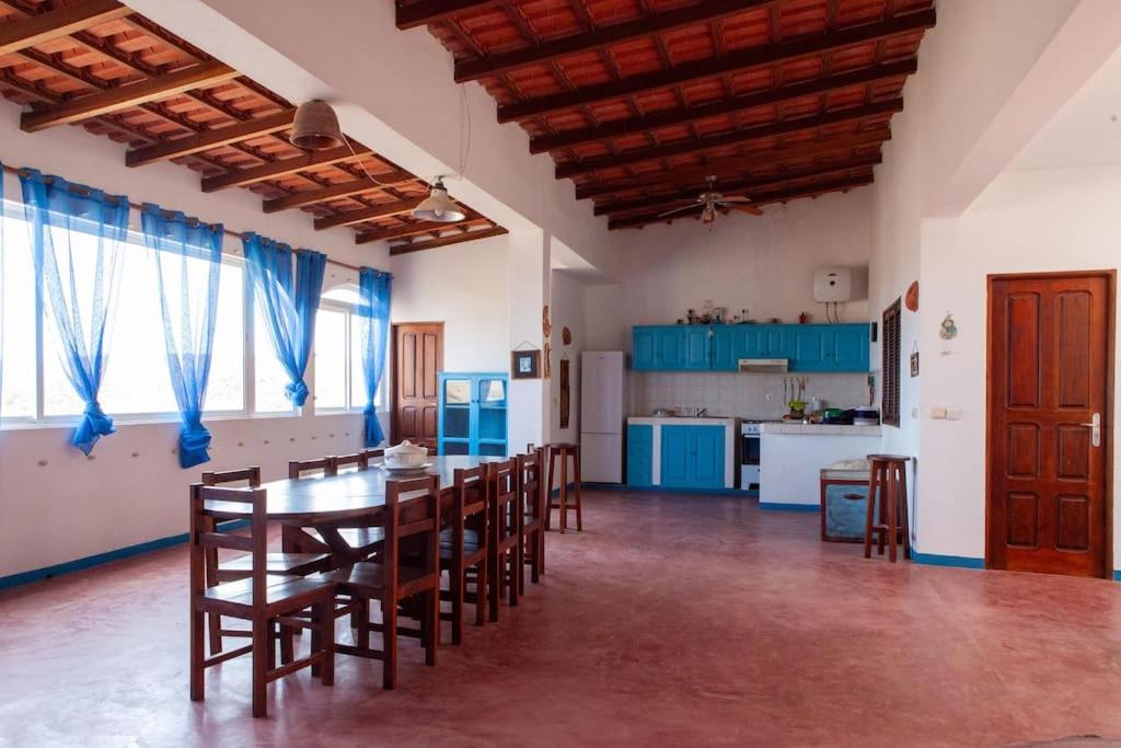 a large room with a table and chairs and a kitchen at Villa de Palma a Ribeira D.Joao in Figueira da Horta