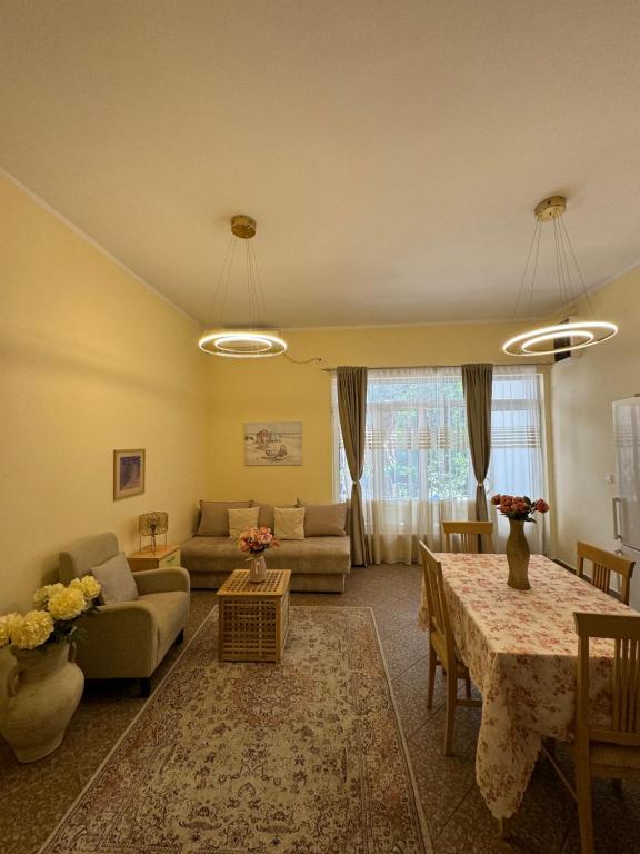 a living room with a couch and a table at Apartment OLIVA1 in Petrovac na Moru