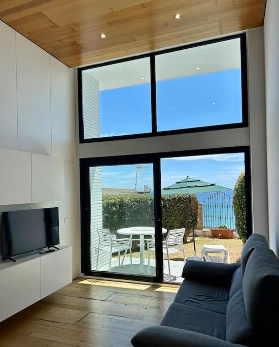 a living room with a couch and a large window at Smile Seaview in Nerja