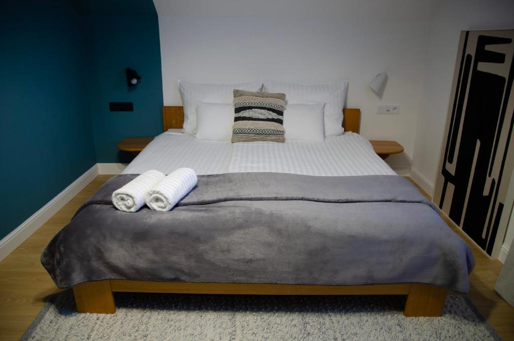 a bedroom with a large bed with two rolled towels at Achilla Bed & Breakfast in Český Krumlov
