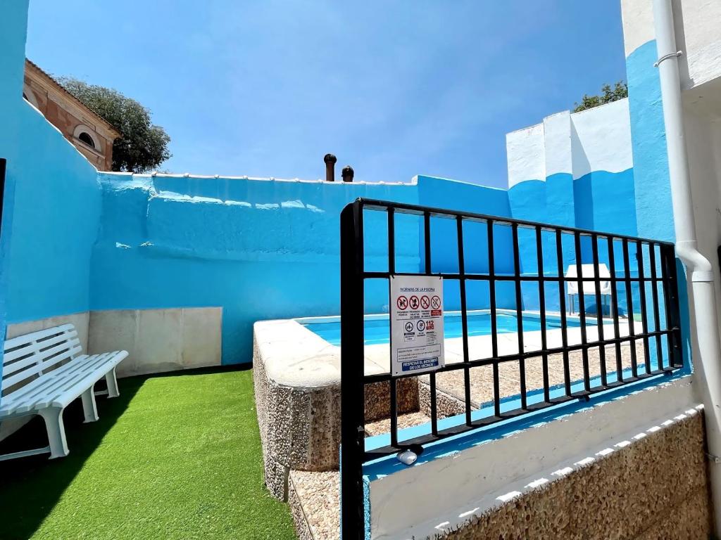 a balcony with a blue fence and a pool at Casa Rural Pernales I in Ruidera