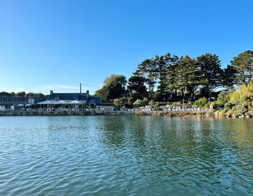a large body of water with a building in the background at Les Voiles Baie de Quiberon - Villa in Plouharnel