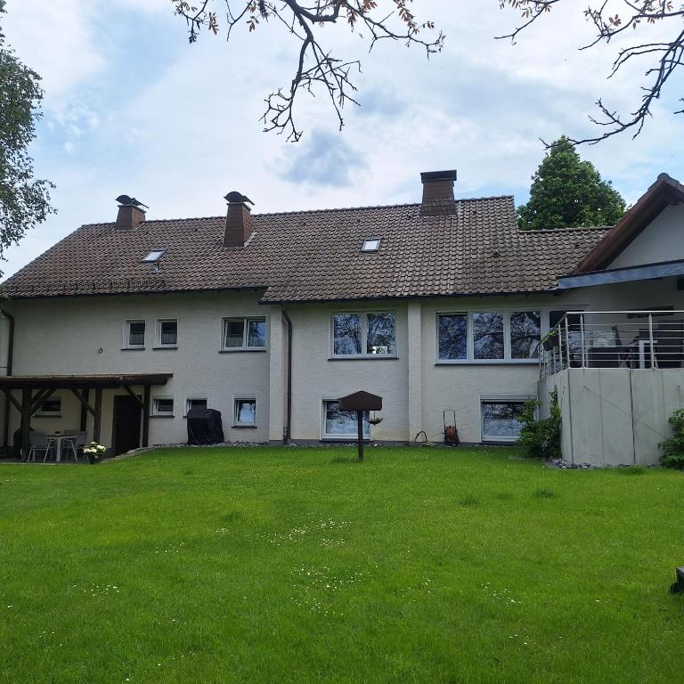 a large white house with a large yard at Ferienwohnung Klee in Neheim-Hüsten
