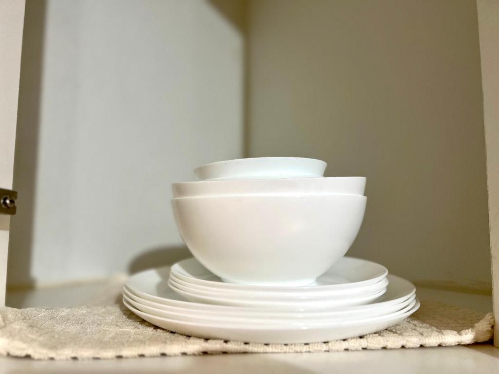 a stack of white bowls and plates on a table at IT Park + fast net in Cebu City