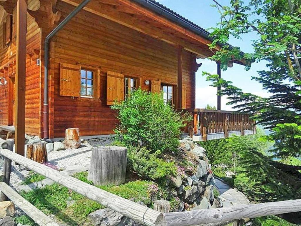 a log cabin with a fence in front of it at Chalet Albert in Les Collons