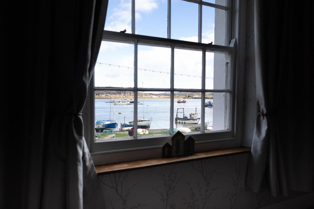 an open window with a view of a marina at Water View Cottage, Conwy in Conwy