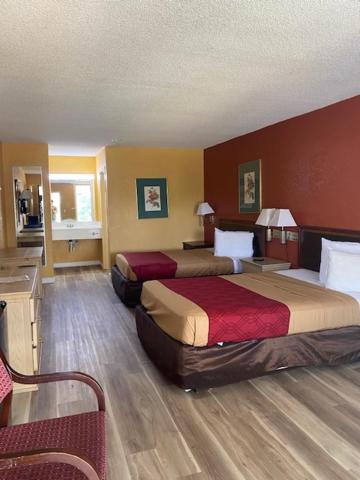 a hotel room with two beds in a room at Orangeburg inn & Suites in Orangeburg