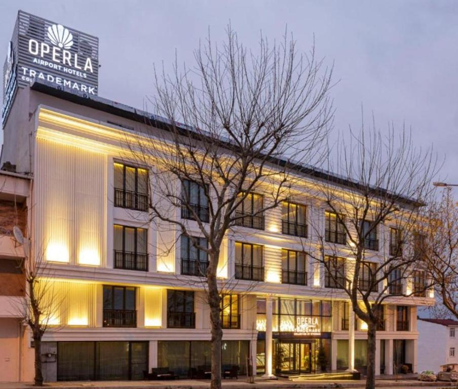 um edifício com um sinal na lateral em Operla Airport Hotels, Trademark Collection by Wyndham em Arnavutköy