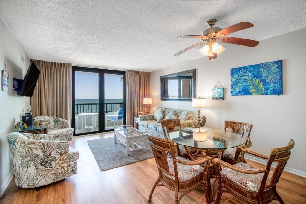 a living room with a table and chairs and a couch at Seawinds, Oceanfront, 2 BR , Indoor Pool, Hot Tub in Myrtle Beach