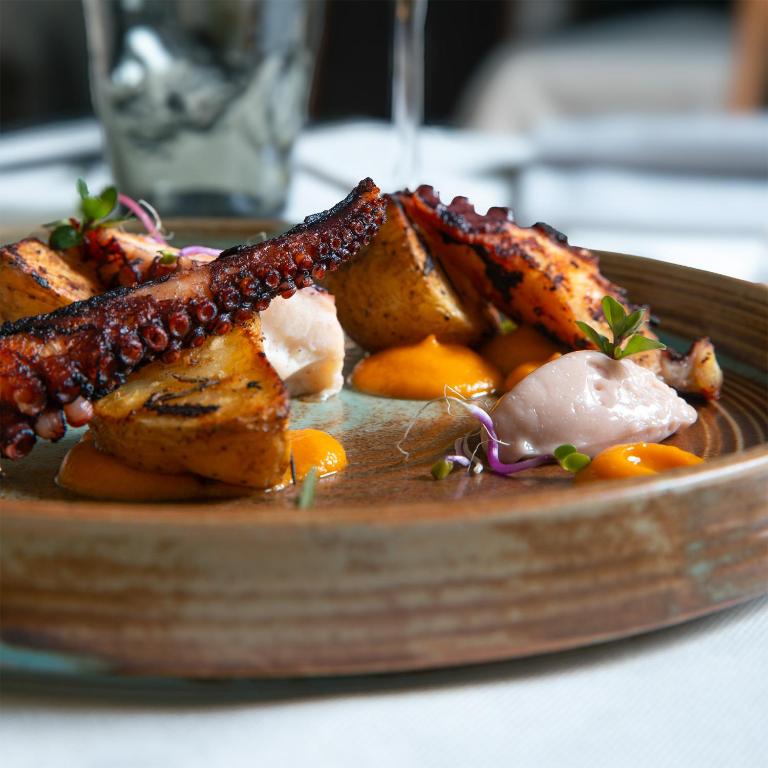 a plate of food with meat and vegetables on a table at Albergo della Posta in Astano
