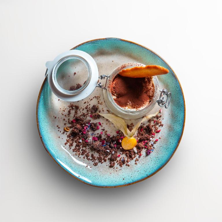 a blue plate with a cup of chocolate on it at Albergo della Posta in Astano