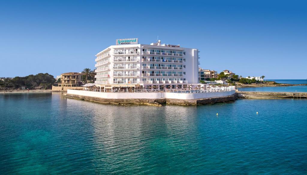 a large white building in the middle of the water at Universal Hotel Marqués in Colònia de Sant Jordi