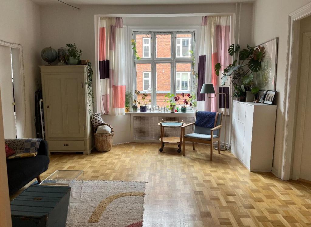 哥本哈根的住宿－ApartmentInCopenhagen Apartment 43，客厅配有桌子和窗户