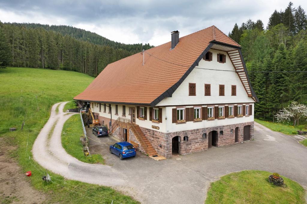 a large house with a car parked in front of it at Sulzerhof in Bad Rippoldsau-Schapbach