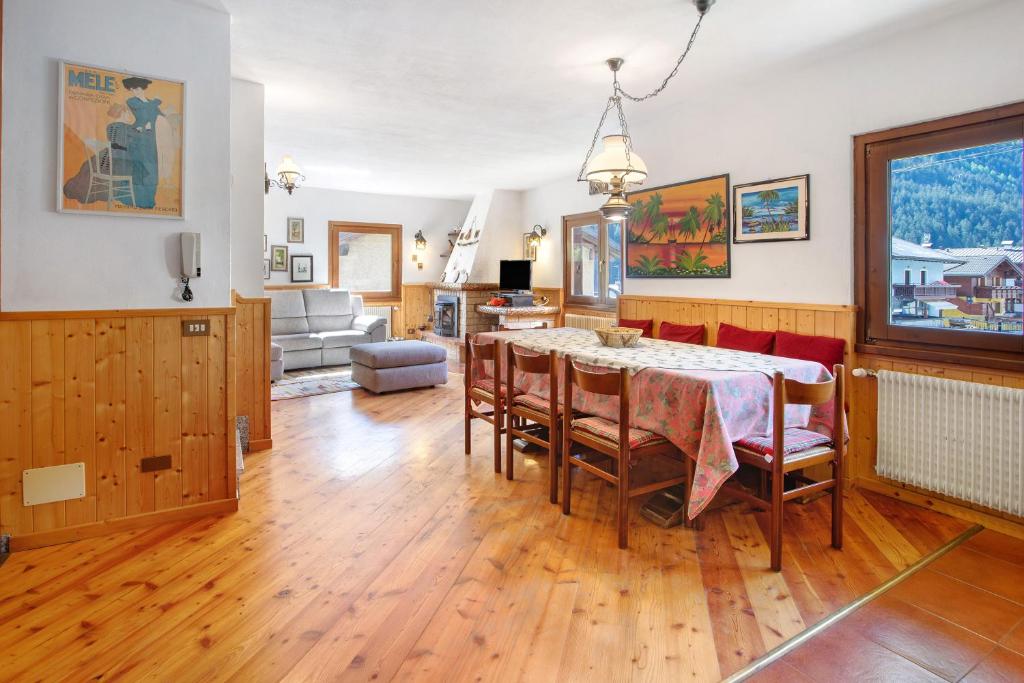 a dining room with a table and chairs at Mountain Chalet close to Bormio in Valdisotto