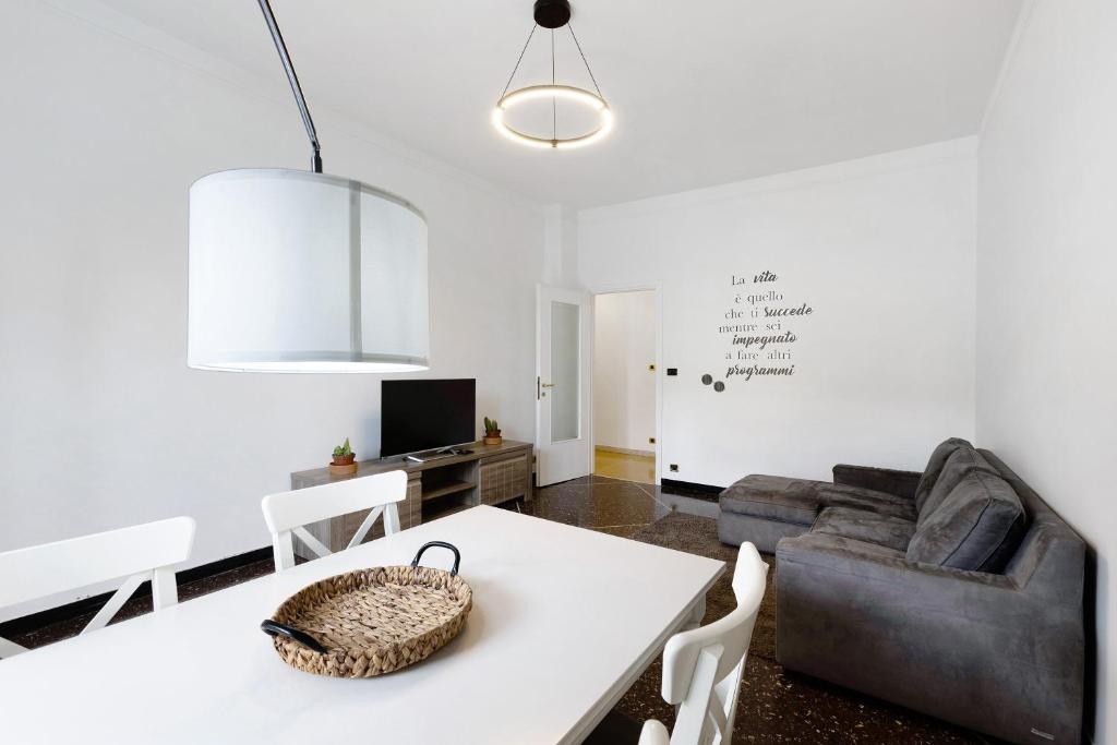 a living room with a white table and a couch at Giardino Sul Mare in Bogliasco