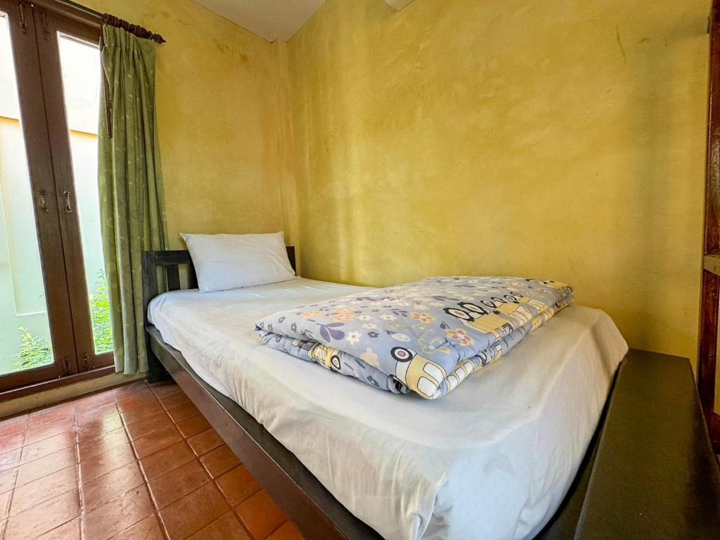 Postel nebo postele na pokoji v ubytování Baan Bali Beach Resort Pranburi