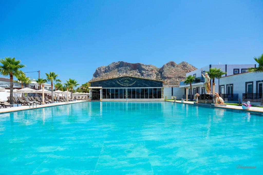 a large swimming pool in front of a resort at Paradice Hotel Luxury Suites-Near zorbas Beach-FREE Breakfast in Stavros