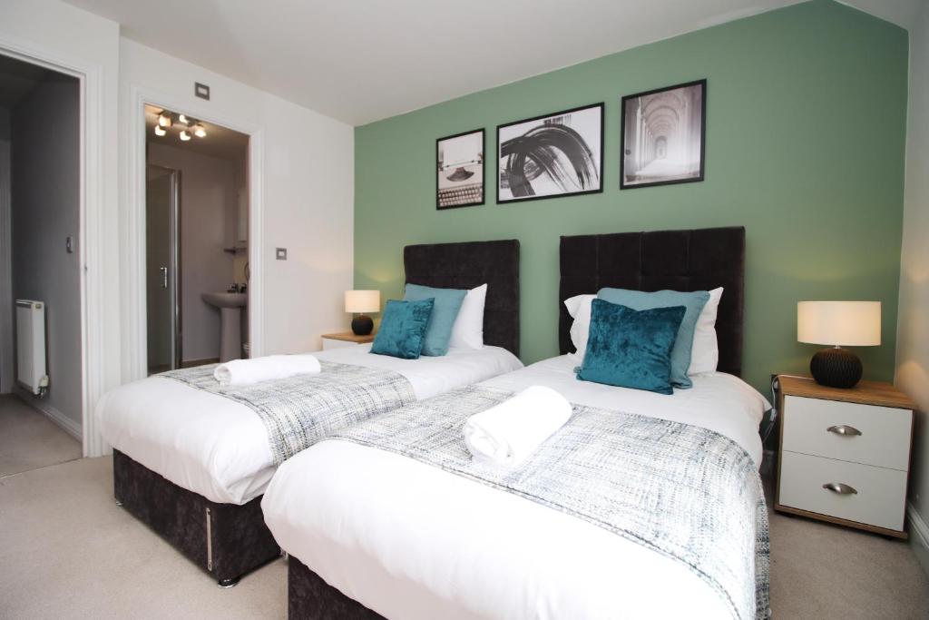 Un pat sau paturi într-o cameră la BRAND NEW Stylish 4 Bedroom House in Cardiff by PureStay