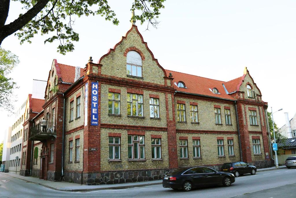 a large brick building on the side of a street at Hostel Lõuna in Pärnu