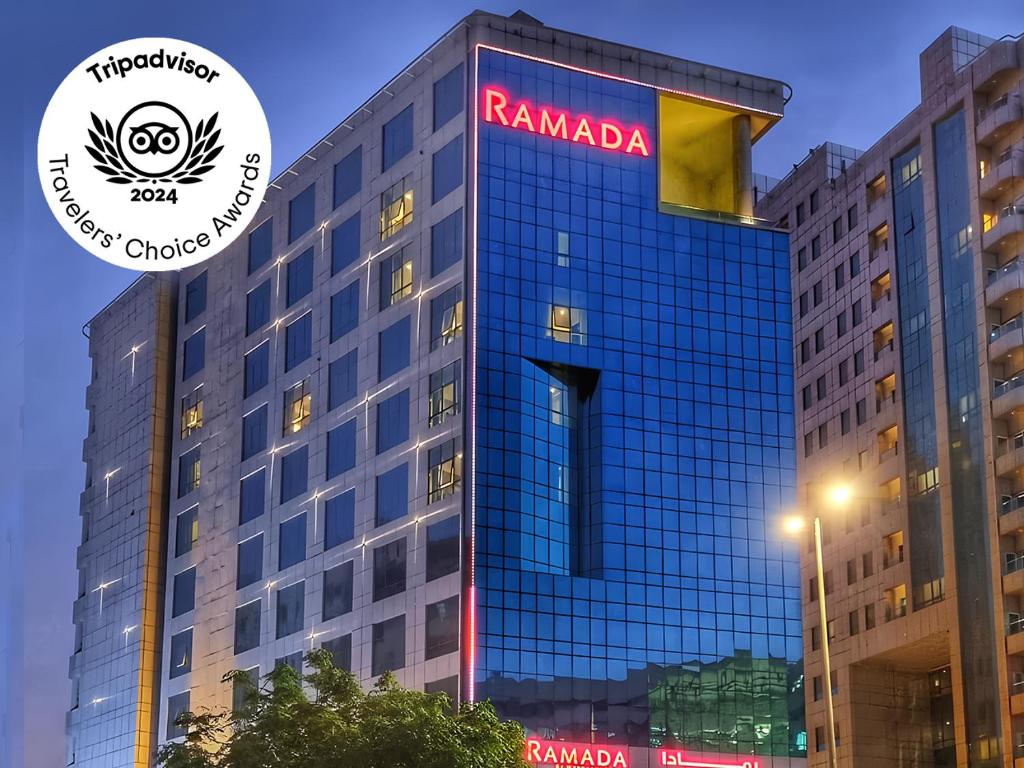 un edificio con un cartel en el costado en Ramada by Wyndham Dubai Barsha Heights, en Dubái