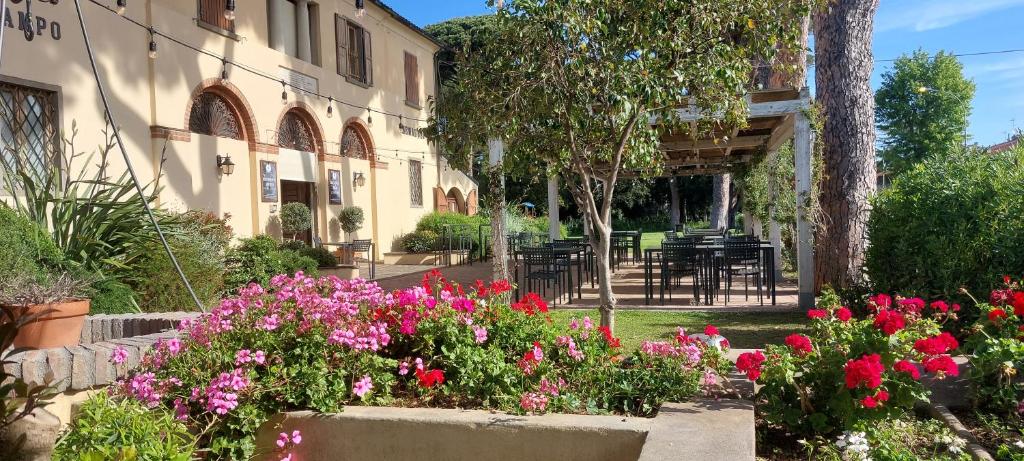 einen Garten mit Blumen vor einem Gebäude in der Unterkunft Locanda Menabuoi in Donoratico