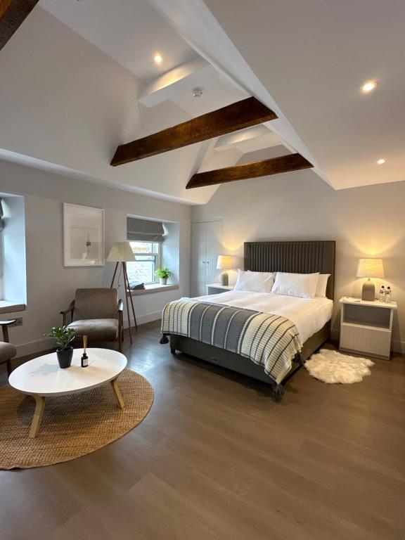 a bedroom with a bed and a table and a couch at Number One - Townhouse in Kinsale