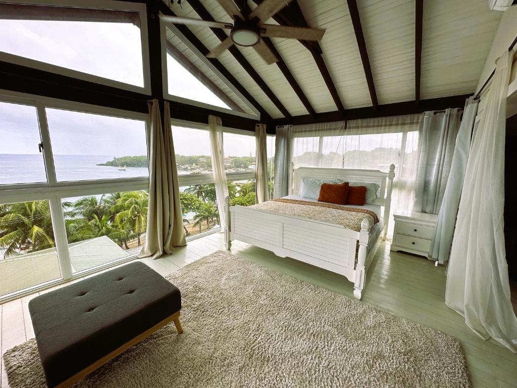 a bedroom with a bed with a view of the ocean at Mira mar Hotel y Restaurante in Roatan