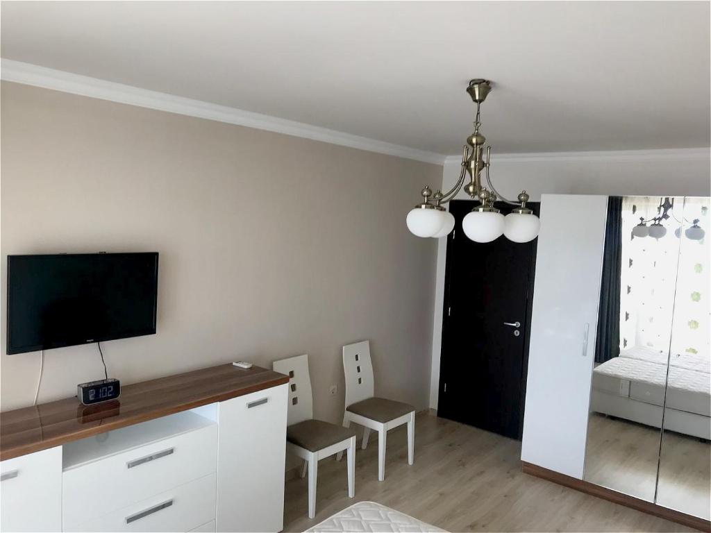A television and/or entertainment centre at Private Super apartments by sea in Apart Hotel !