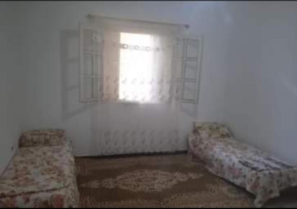 a room with two beds and a window at صلامندر in La Salamandre