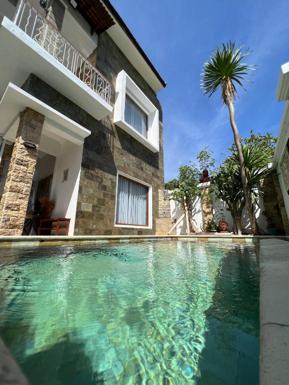 a swimming pool in front of a house at Hills House Villa by Globalstay - Jimbaran x Balangan x GWK in Jimbaran