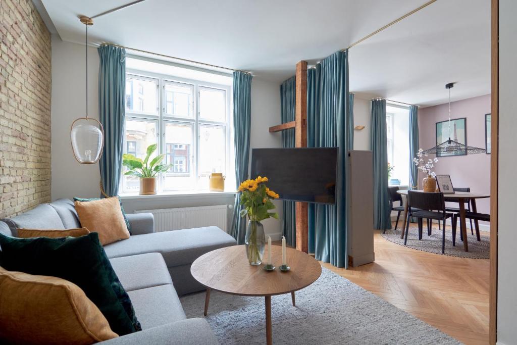 a living room with a couch and a table at Cherryy in Copenhagen