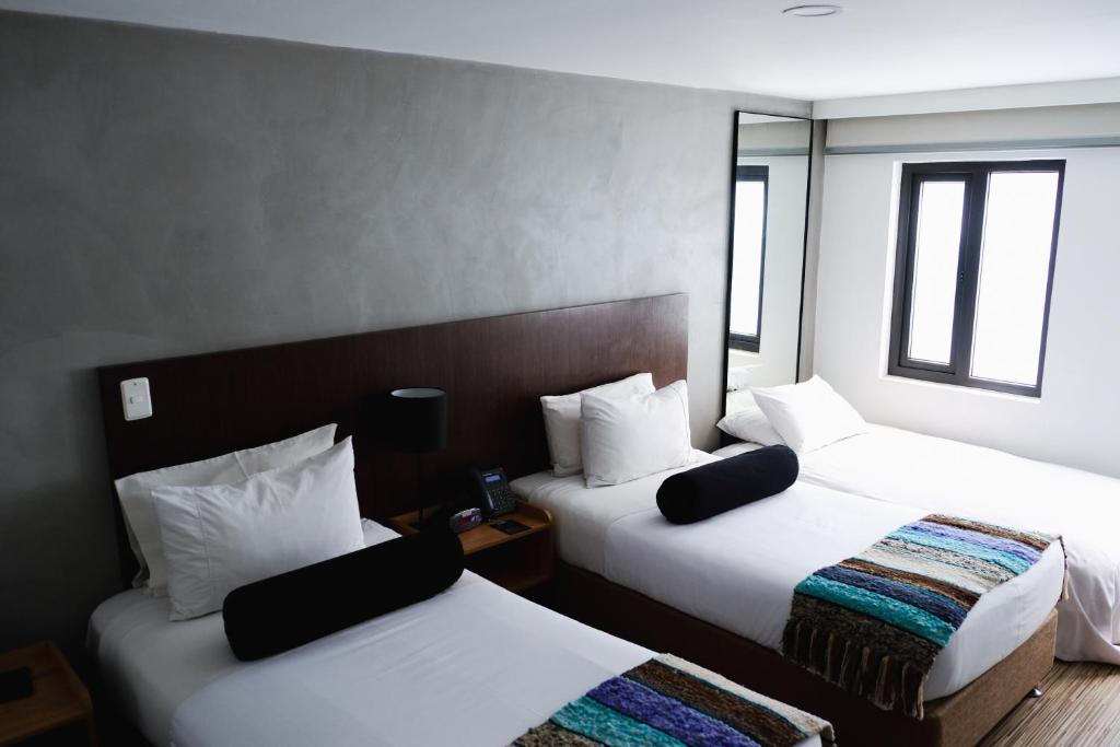 Postel nebo postele na pokoji v ubytování Hotel DC Feria