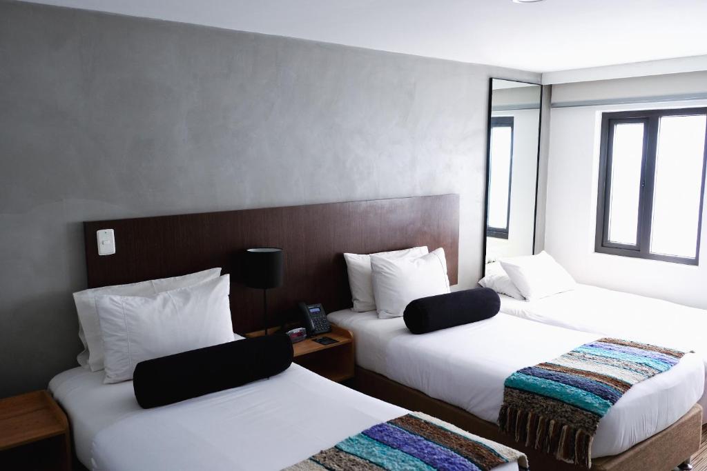 Postel nebo postele na pokoji v ubytování Hotel DC Feria