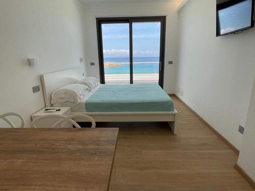 a bedroom with a bed and a view of the ocean at Casa Vacanza Acquamarina in Porto Torres