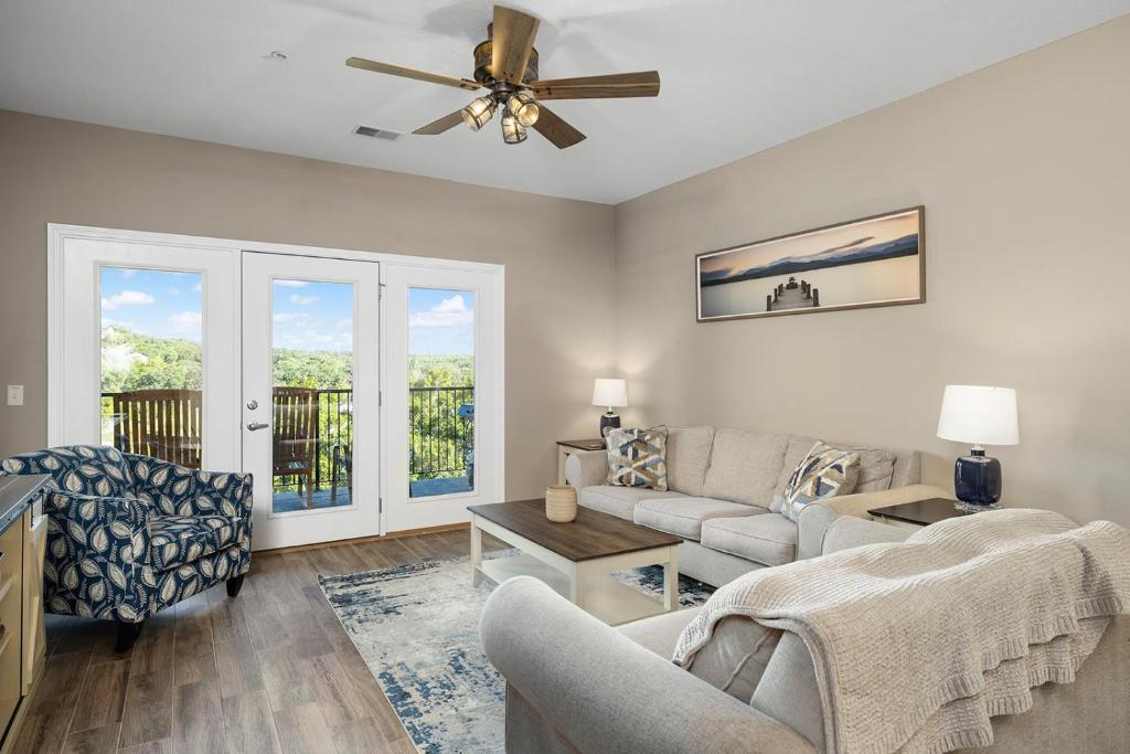 a living room with a couch and a ceiling fan at Condo #353 in Branson