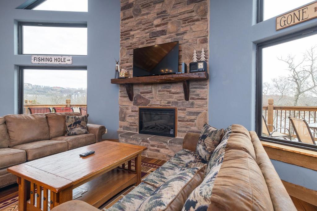 a living room with a couch and a fireplace at Lodge 17 in Branson