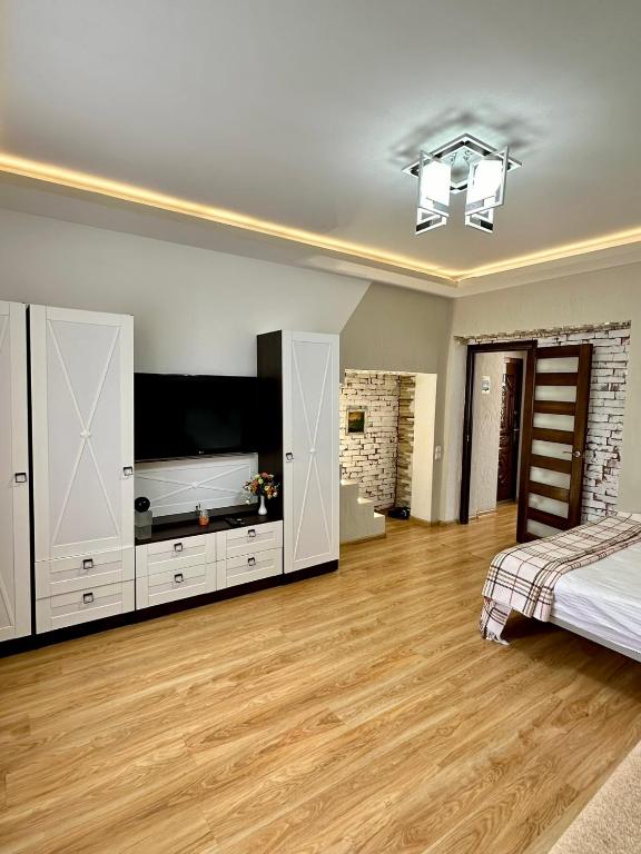 una camera da letto con un letto e una televisione di HomeSweetHome a Chişinău