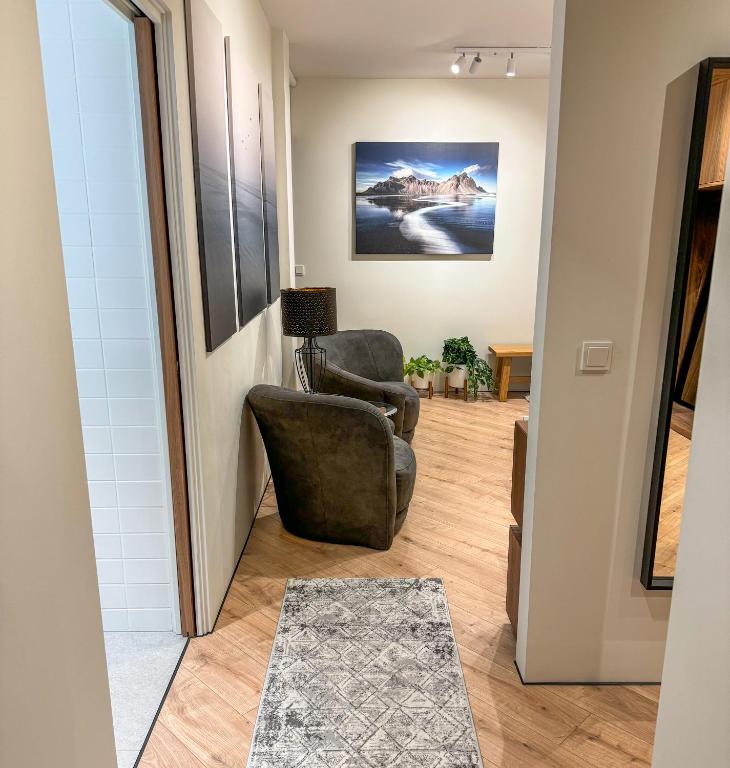a living room with two chairs and a rug at Luxury studio with balcony in Reykjavík