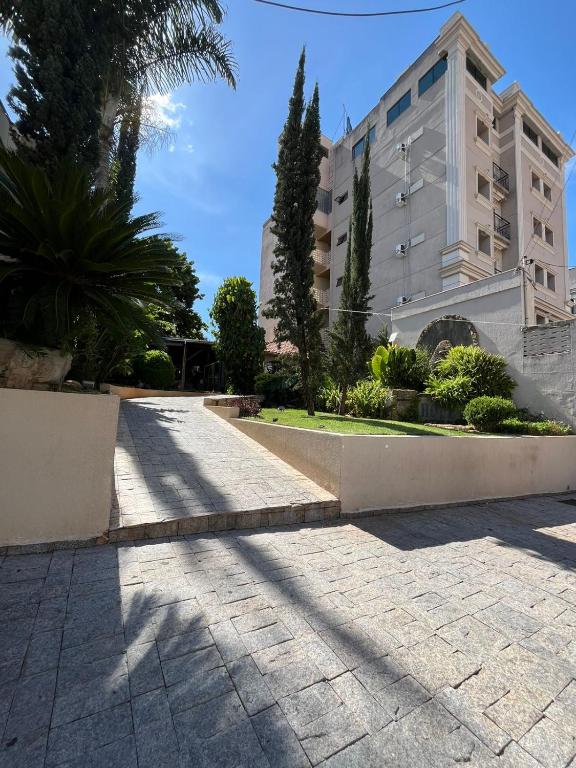 a shadow of a building in front of a building at Hotel Nações Plaza in Bauru
