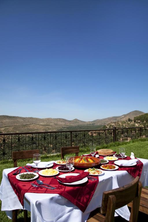 a table with plates of food on top of it at Kasbah Illy in Demnat