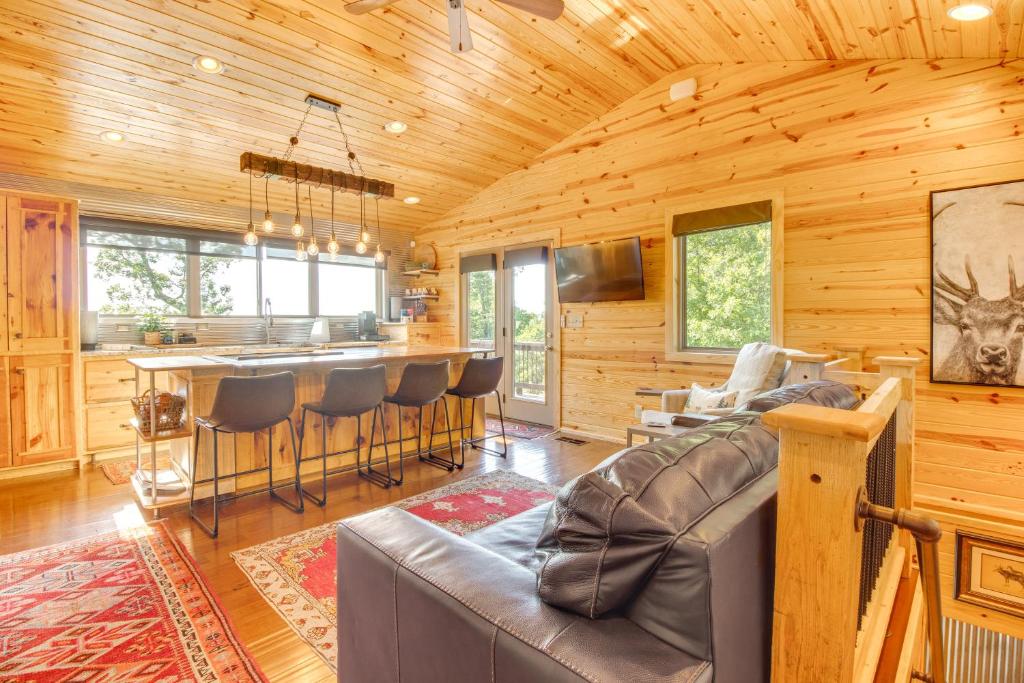 a living room with a couch and a bar at Mountain Home Cabin Rental with Fire Pit! in Mountain Home