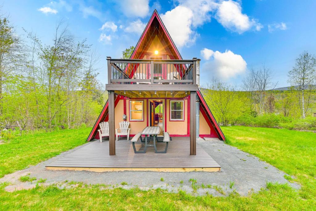 a small house with a porch and a deck at Charming Hunter A-Frame Walk to Ski Lift! in Lanesville