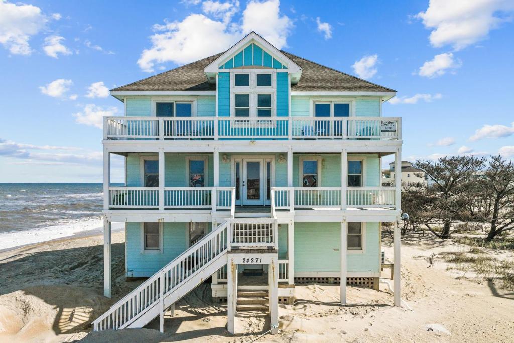 a blue house on the beach with the ocean at 7042 - Whistling Oyster by Resort Realty in Rodanthe