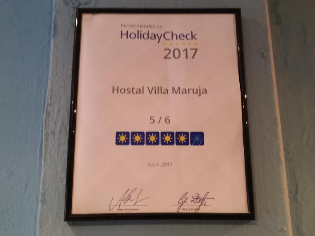 a sign for the hollywoodcheck hospitalilla mandapa at Hostal Villa Maruja in El Arenal