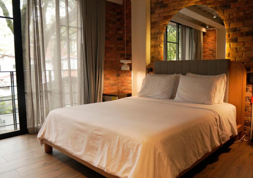 Postel nebo postele na pokoji v ubytování Nomada Hotel Origen